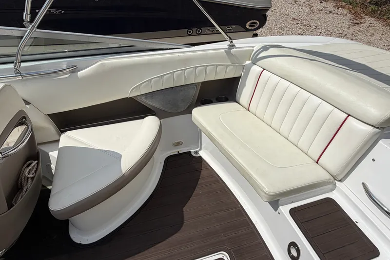 Slide: The Image of Interior of a 2007 Cobalt 250 boat with white leather seating and wood flooring. - 17