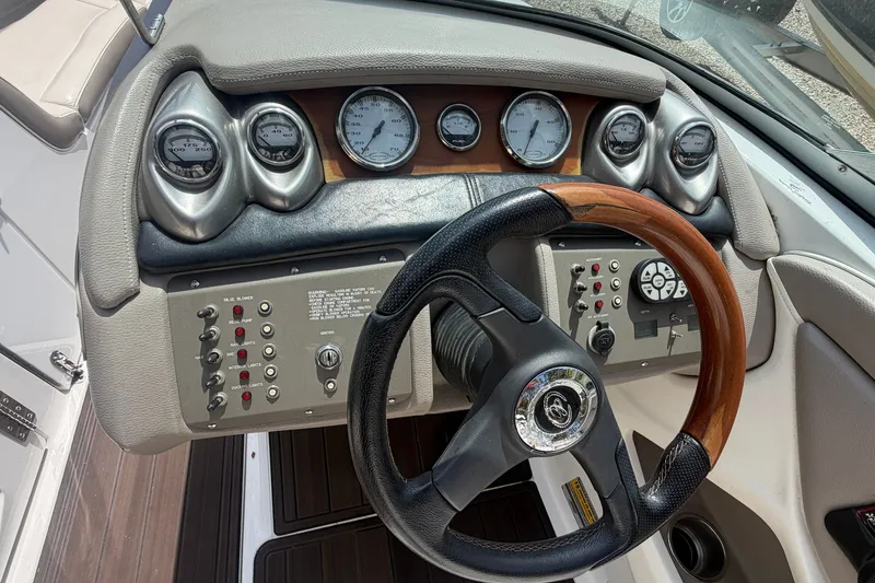 Slide: The Image of Dashboard of a 2007 Cobalt 250 boat with gauges and steering wheel. - 15