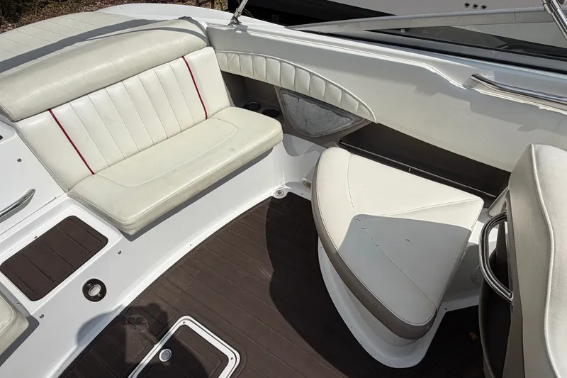 Slide: The Image of Interior seating of a 2007 Cobalt 250 boat with white and red upholstery. - 16