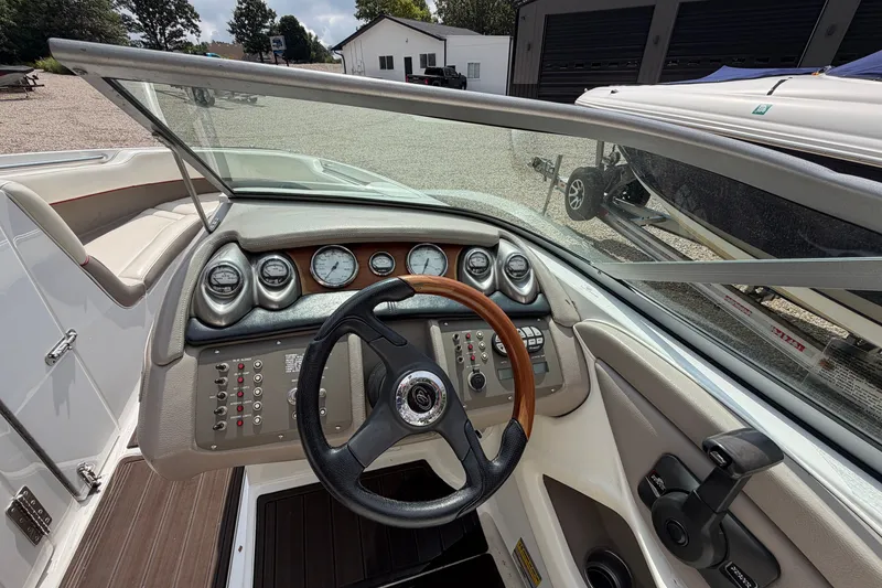 Slide: The Image of Steering console of a 2007 Cobalt 250 boat with gauges and controls. - 14