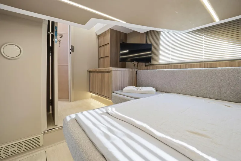 Slide: The Image of Modern interior of Hanover 447 yacht, featuring a cozy bed, TV, and sleek wooden accents, 2026 model. - 49