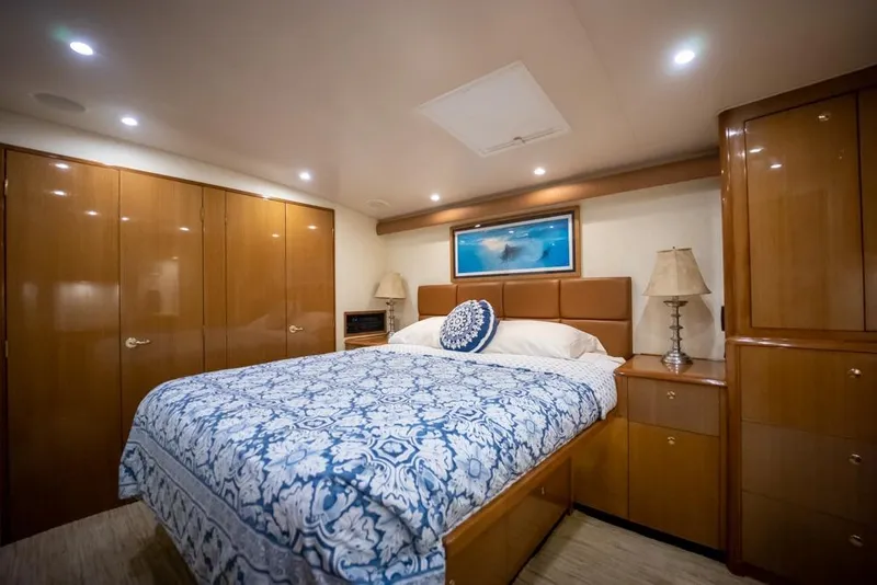 Slide: The Image of Luxurious bedroom interior of 2003 Viking 65 EB yacht with elegant wood cabinetry. - 46