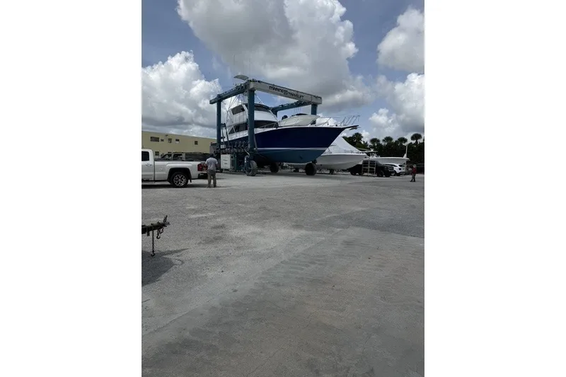 Slide: The Image of 2003 Viking 65 EB yacht on travel lift at marina, cloudy sky background. - 56