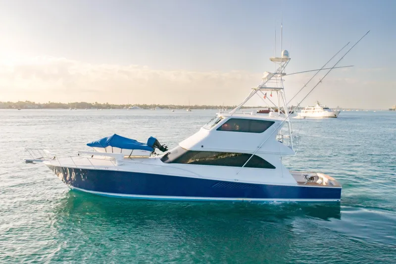 The Image of 2003 Viking 65 EB yacht cruising on calm waters under a clear sky. - 0