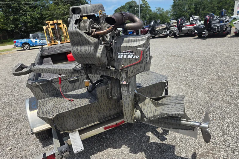 Slide: The Image of 2022 Gator Tail Extreme series boat motor on a trailer in a parking lot. - 8