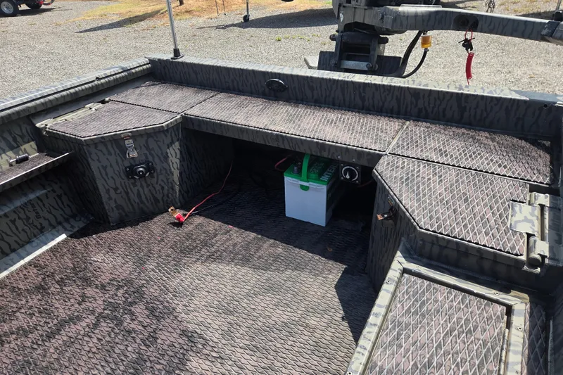 Slide: The Image of 2022 Gator Tail Extreme series boat interior with camo design and battery storage. - 15