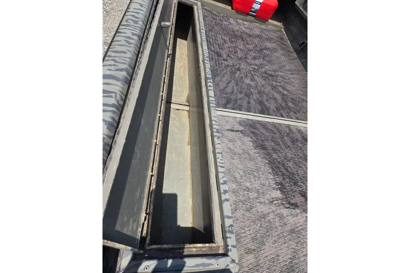 Slide: The Image of Open storage compartment on a 2022 Gator Tail Extreme series boat. - 12
