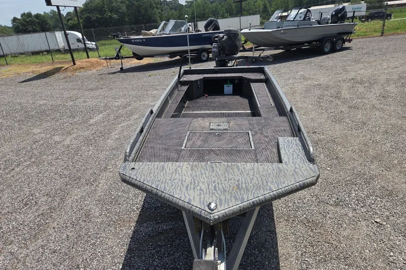 Slide: The Image of 2022 Gator Tail Extreme series boat on gravel lot, surrounded by other boats. - 3