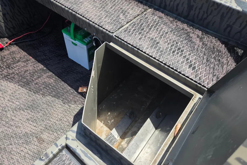Slide: The Image of Open storage compartment in 2022 Gator Tail Extreme series boat interior. - 11