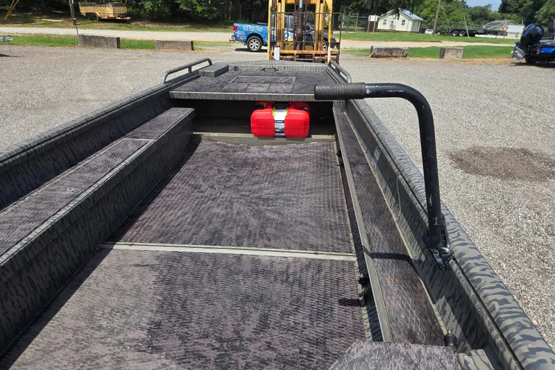Slide: The Image of 2022 Gator Tail Extreme series boat interior with red fuel tanks on a sunny day. - 10