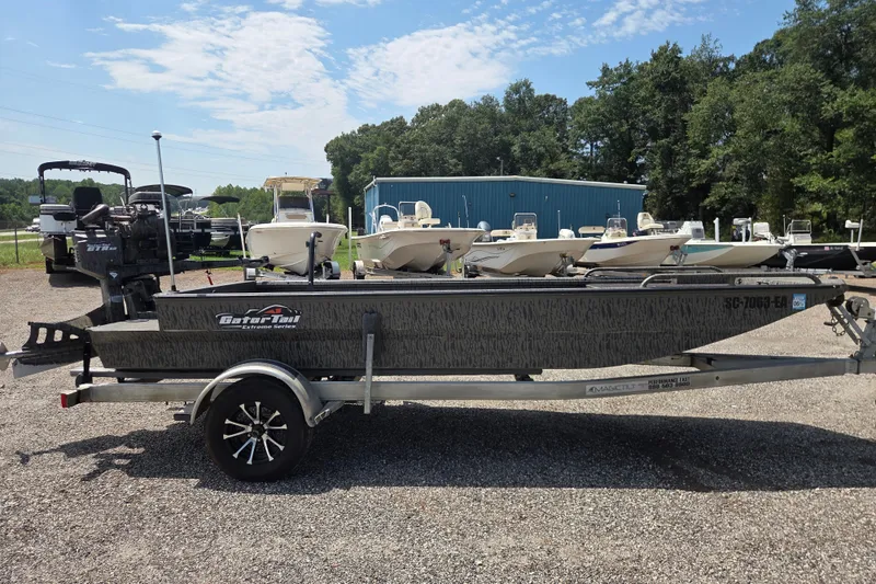 Slide: The Image of 2022 Gator Tail Extreme Series boat on trailer, parked outdoors with other boats. - 5