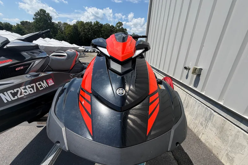 Slide: The Image of 2022 Yamaha WaveRunner VX Cruiser HO in black and red, parked outdoors. - 1