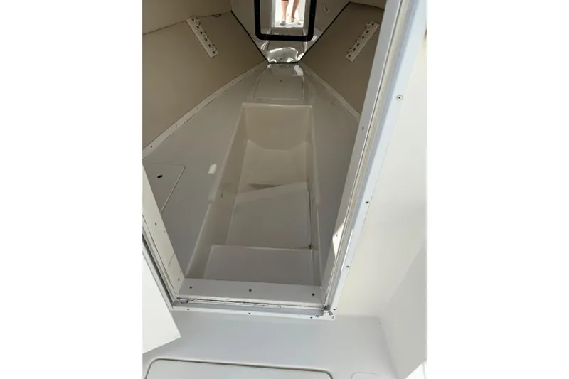 Slide: The Image of 2001 Marlago 35 Cuddy cabin interior, featuring sleek white design and compact layout. - 9