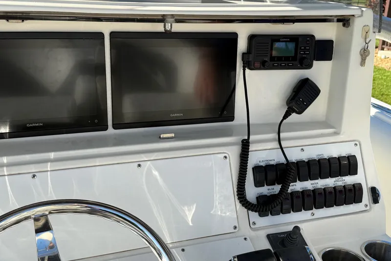 Slide: The Image of Control panel of a 2001 Marlago 35 Cuddy boat with Garmin displays. - 13