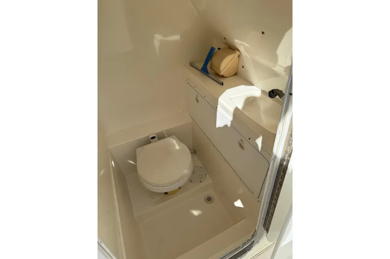 Slide: The Image of 2001 Marlago 35 Cuddy boat interior with compact bathroom facilities. - 11