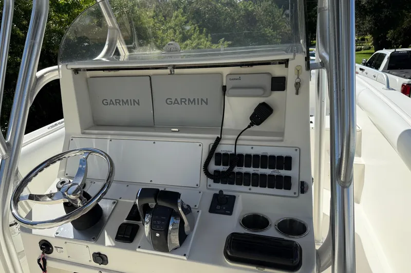 Slide: The Image of 2001 Marlago 35 Cuddy boat dashboard with Garmin navigation systems and steering wheel. - 20