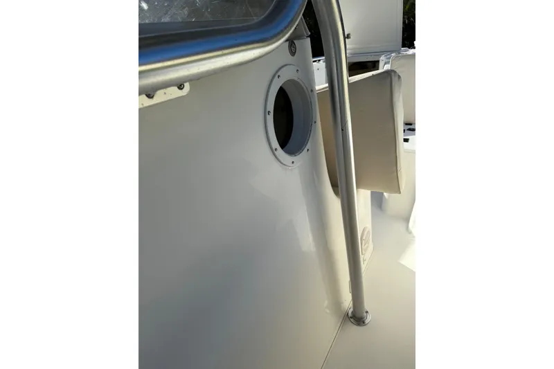 Slide: The Image of 2001 Marlago 35 Cuddy boat interior with metal railing and porthole detail. - 30