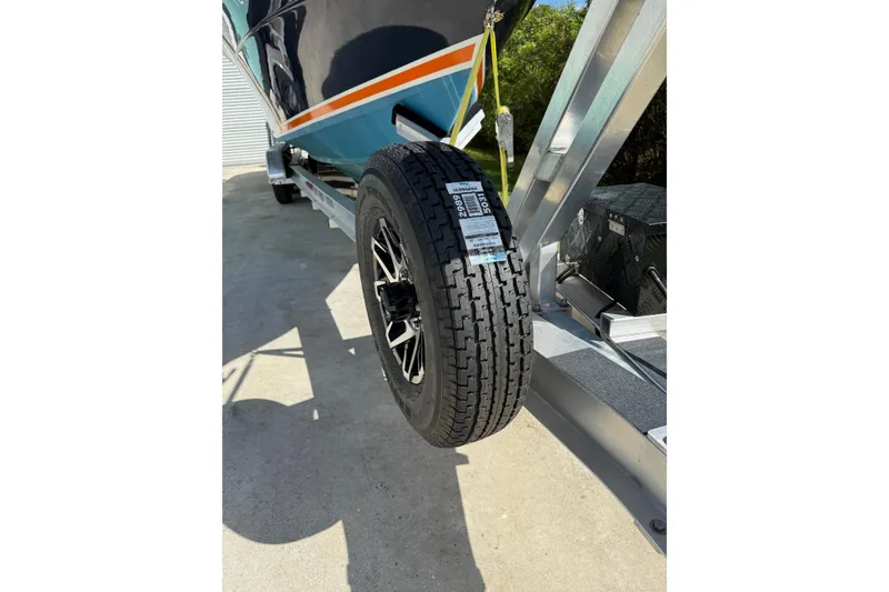 Slide: The Image of 2001 Marlago 35 Cuddy boat on trailer, close-up of tire and hull. - 16
