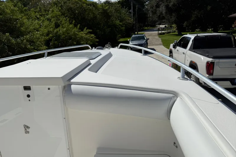 Slide: The Image of 2001 Marlago 35 Cuddy boat deck with railing, parked near vehicles. - 8