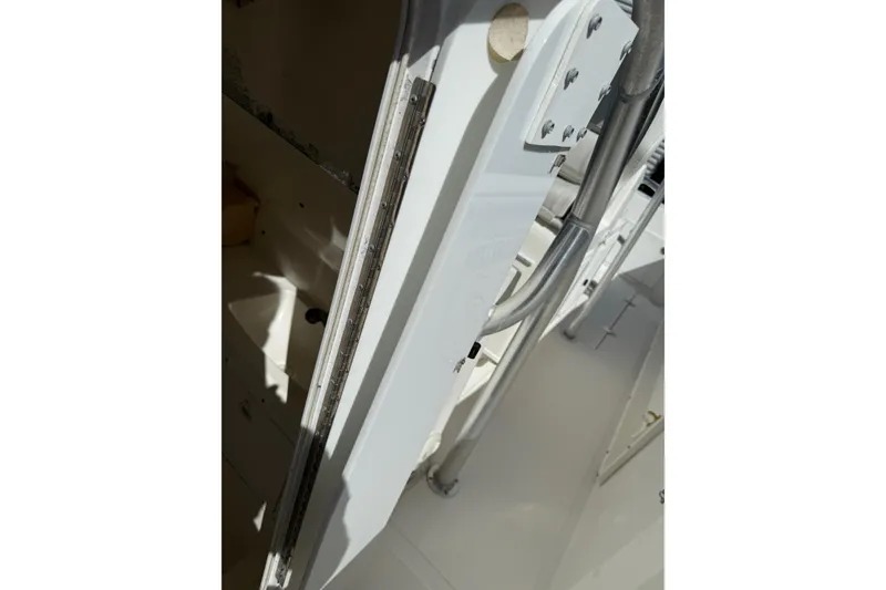 Slide: The Image of 2001 Marlago 35 Cuddy boat interior detail with metal and fiberglass components. - 12