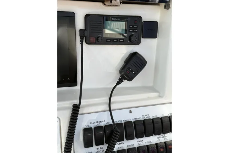 Slide: The Image of Garmin marine radio and controls on 2001 Marlago 35 Cuddy boat dashboard. - 24