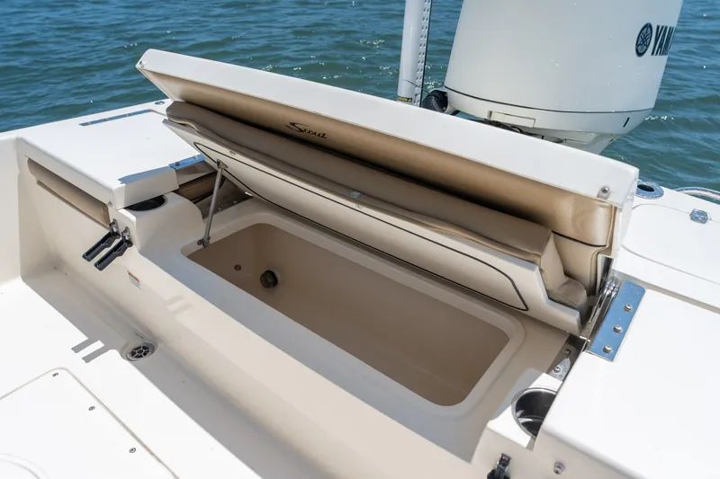 Slide: The Image of 2019 Scout 251 XSS boat with open storage compartment on deck. - 23