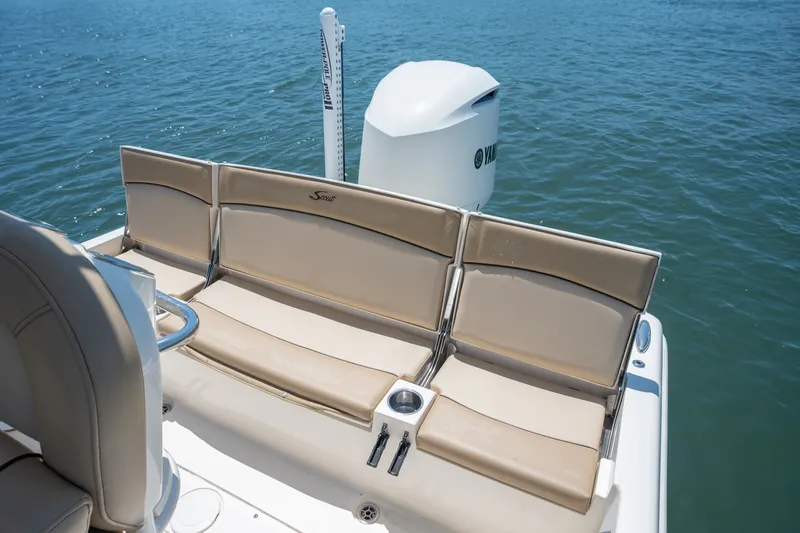 Slide: The Image of 2019 Scout 251 XSS boat with beige seating and Yamaha engine on water. - 10