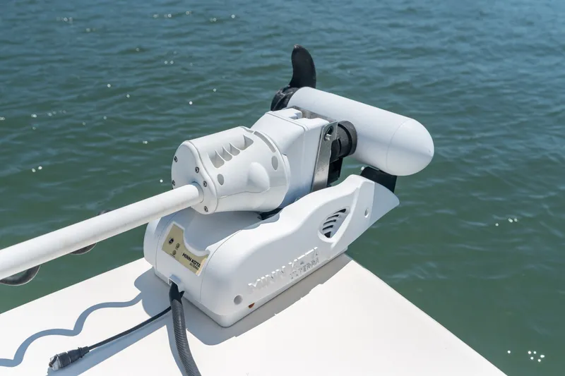 Slide: The Image of Minn Kota trolling motor on 2019 Scout 251 XSS boat, positioned over water. - 22