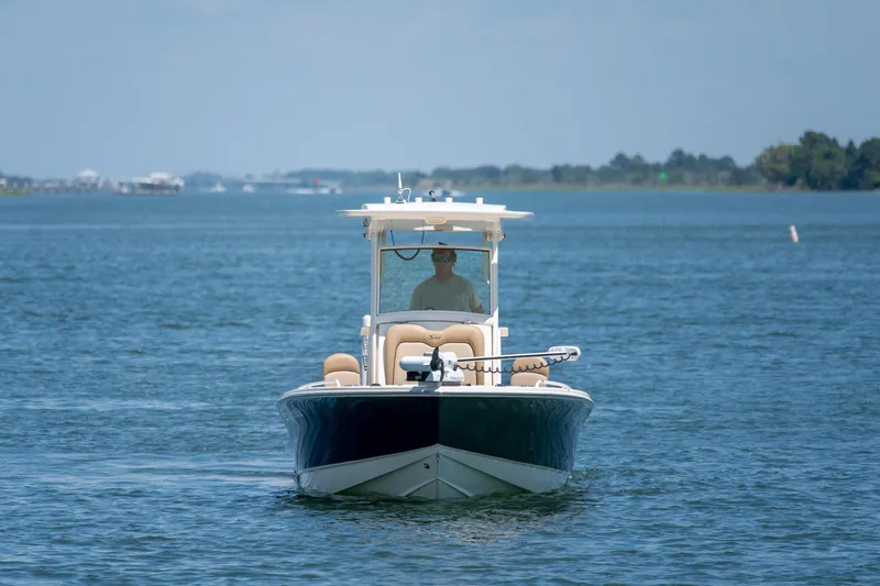 Slide: The Image of 2019 Scout 251 XSS boat cruising on a calm blue lake. - 3