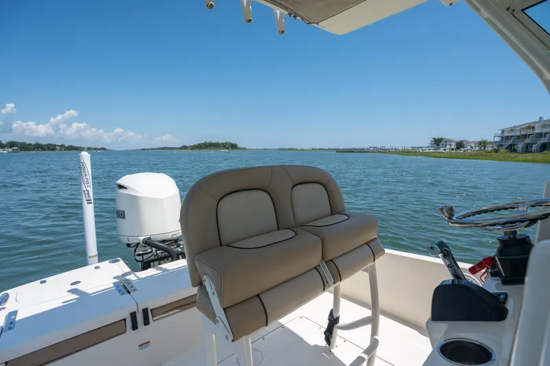 Slide: The Image of 2019 Scout 251 XSS boat interior with Yamaha engine on a sunny day. - 11