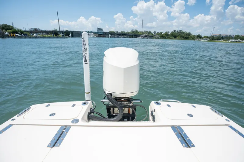 Slide: The Image of 2019 Scout 251 XSS boat with outboard motor on calm water. - 8