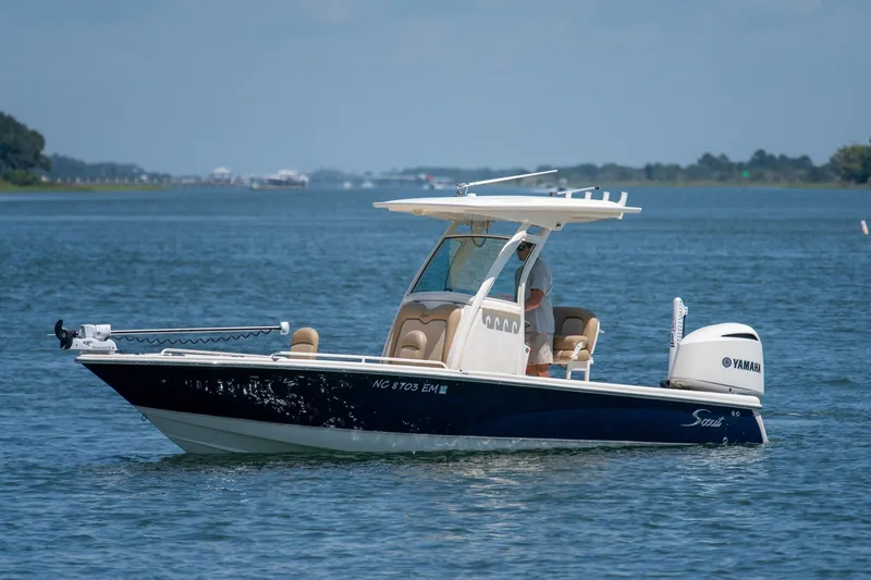 Slide: The Image of 2019 Scout 251 XSS boat with Yamaha engine cruising on a calm lake. - 4