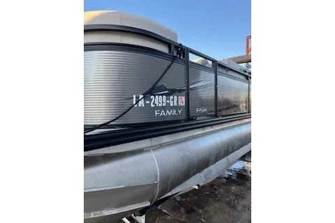 Slide: The Image of 2023 Angler Qwest 22' Pro Family Fish pontoon boat, side view, docked. - 7