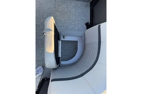 Slide: The Image of 2023 Angler Qwest 22' Pro Family Fish boat interior with gray seating and flooring. - 10