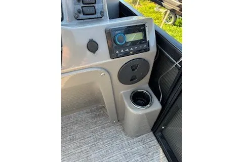 Slide: The Image of 2023 Angler Qwest 22' Pro Family Fish boat console with stereo and cup holder. - 24