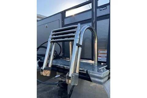 Slide: The Image of 2023 Angler Qwest 22' Pro Family Fish boat ladder, stainless steel, folded position. - 3