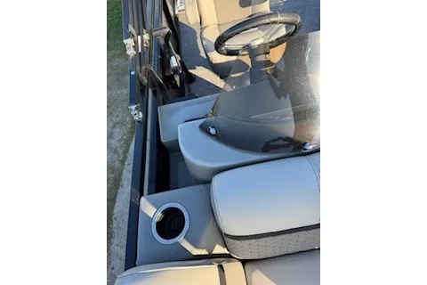 Slide: The Image of 2023 Angler Qwest 22' Pro Family Fish boat interior with steering wheel and seating. - 21