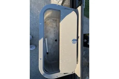 Slide: The Image of 2023 Angler Qwest 22' Pro Family Fish livewell with open lid, showcasing interior. - 29