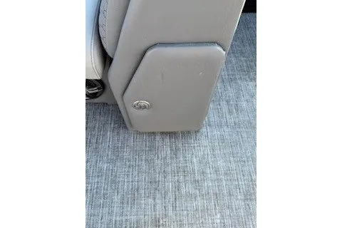Slide: The Image of 2023 Angler Qwest 22' Pro Family Fish boat interior with gray upholstery and flooring. - 23