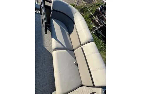 Slide: The Image of 2023 Angler Qwest 22' Pro Family Fish boat with beige seating. - 19