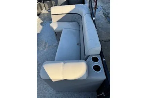 Slide: The Image of 2023 Angler Qwest 22' Pro Family Fish boat seating with cup holders, gray upholstery. - 13