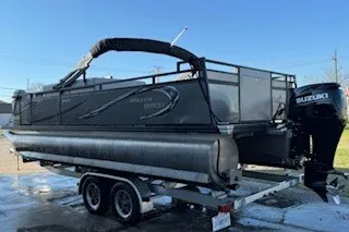 The Image of 2023 Angler Qwest 22' Pro Family Fish pontoon boat on trailer with Suzuki outboard motor. - 1