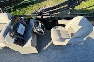 Slide: The Image of 2023 Angler Qwest 22' Pro Family Fish boat interior with steering console and seating. - 17