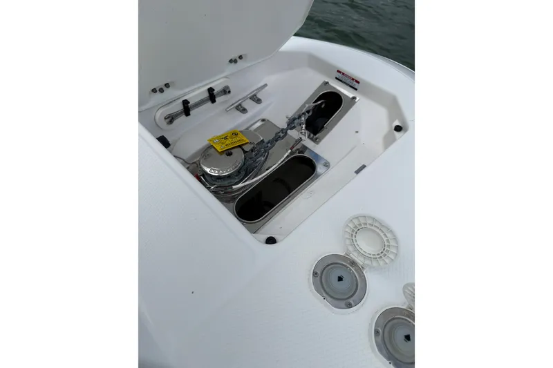Slide: The Image of 2019 Robalo R272 Center Console anchor compartment with winch and chain storage. - 26