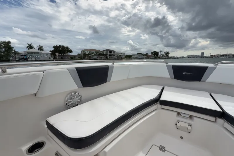 Slide: The Image of 2019 Robalo R272 Center Console boat interior with cushioned seating and waterfront view. - 16