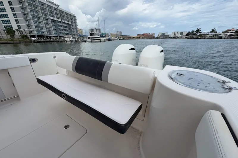 Slide: The Image of 2019 Robalo R272 Center Console boat with seating, docked near waterfront buildings. - 21
