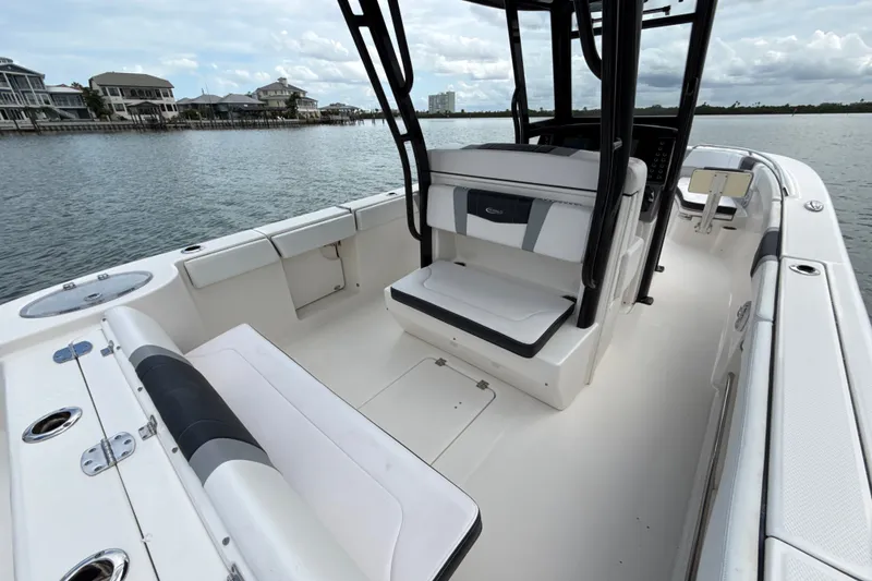 Slide: The Image of 2019 Robalo R272 Center Console boat interior with seating, on calm water. - 13