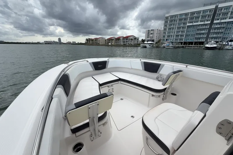 Slide: The Image of 2019 Robalo R272 Center Console boat interior with waterfront view and cloudy sky. - 19