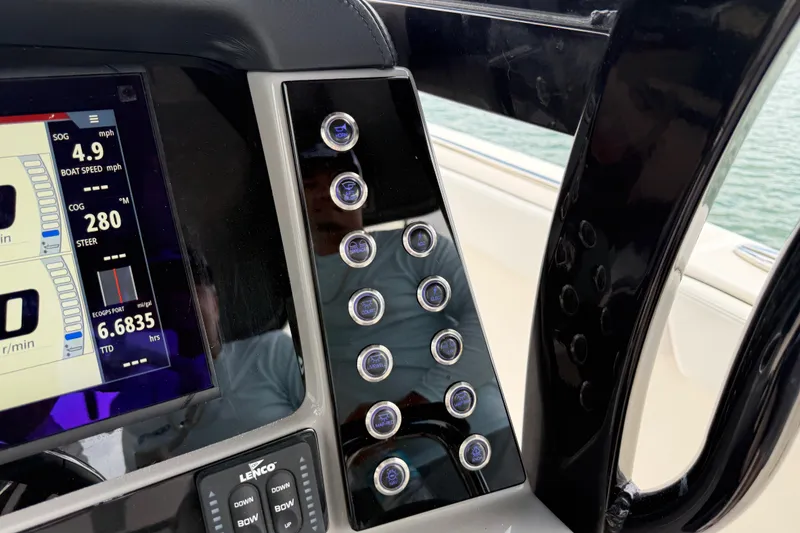 Slide: The Image of 2019 Robalo R272 Center Console dashboard with digital display and control buttons. - 24