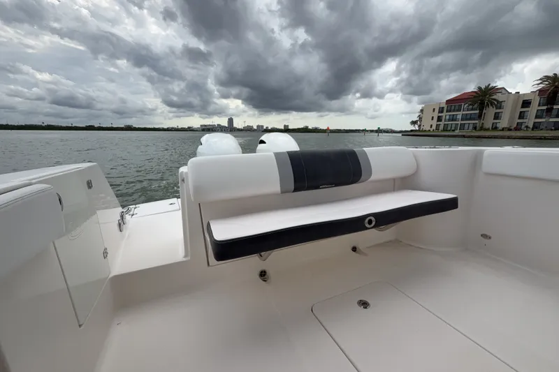 Slide: The Image of 2019 Robalo R272 Center Console boat with seating, under cloudy sky, near waterfront buildings. - 22